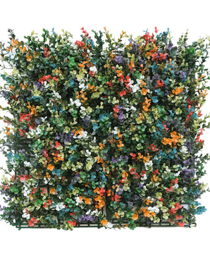 De Kunsthaag Buxus multi-color 50x50 cm UV is een vierkant paneel van dicht kunstgroen met kleine bloemen in oranje, geel, wit, paars en rood tegen een witte achtergrond.