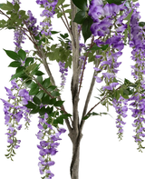 Een close-up van de Kunstplant Blauweregen 210 cm, met trossen hangende paarse bloemen en groene bladeren op houtachtige stengels, tegen een witte achtergrond.