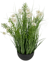 De Kunstgras witte Gesang Bloem uiengraspot (56cm, brandvertragend) heeft hoge, grasachtige groene bladeren en delicate witte bloemen in een zwarte pot voor een weelderige, natuurlijke uitstraling.